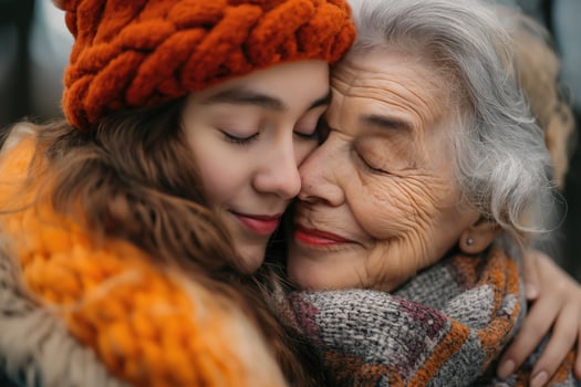 AI generated Grandmother and granddaughter in knitted hats and scarves hugging each other. Mother's day photo