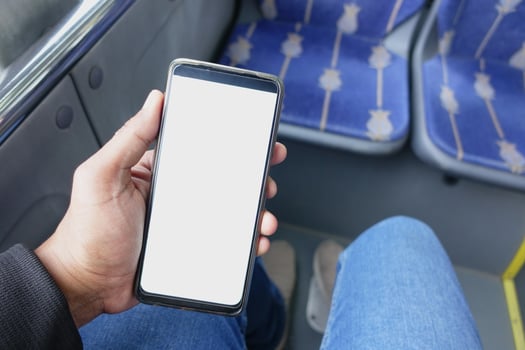 passenger sitting in a bus using his phone. photo