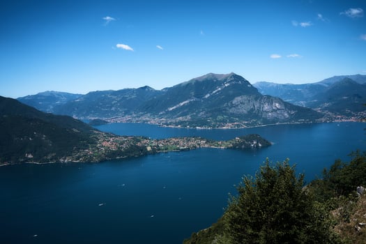 Lake Como with charming yachts surrounded by hills photo