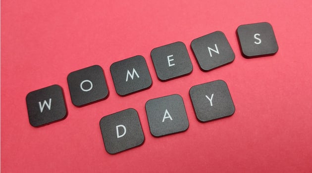 Words women's day made of black keyboard keys on red background. photo