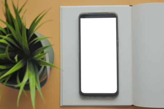 top view of smart phone and notepad on table photo