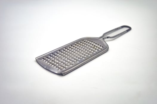 a stainless steel cheese grater isolated on a white background photo