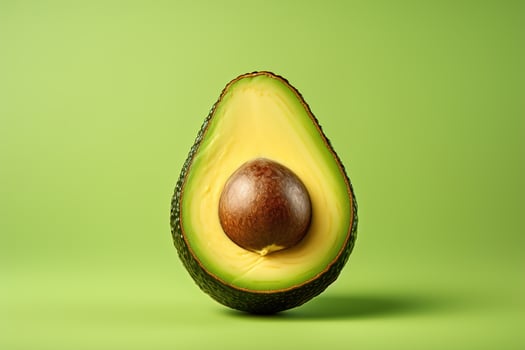 AI generated Avocado with a pit in a section on a green background, food minimalism photo