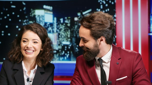 Midnight show hosts covers latest news, going live on international television program and presenting daily events. Media reporters hosting entertainment segment on late night talk show. photo