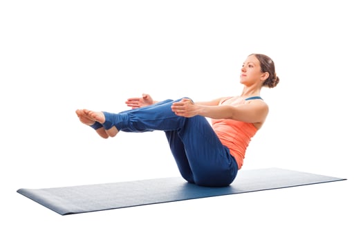 Sporty fit woman doing Ashtanga Vinyasa yoga asana Paripurna navasana photo