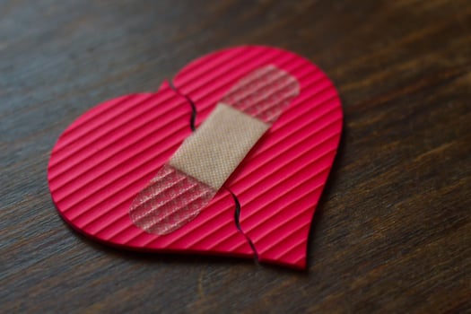 broken heart with brand adhesive bandages - blur photo