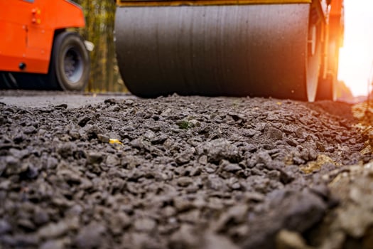 Fresh asphalt on highway construction site. Industrial pavement machine laying. photo