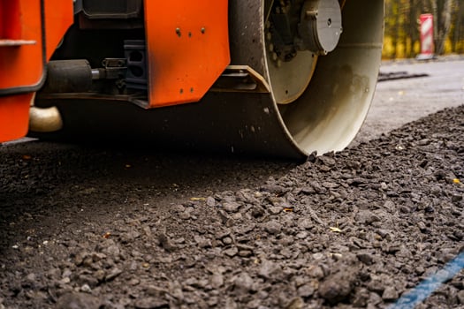 Industrial pavement truck. Laying fresh asphalt on construction site. Heavy machine industry. Mechanical engineering. photo