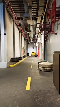 a large room with yellow lines and yellow chairs photo