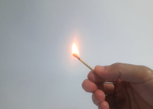 a man lighting a wooden match photo
