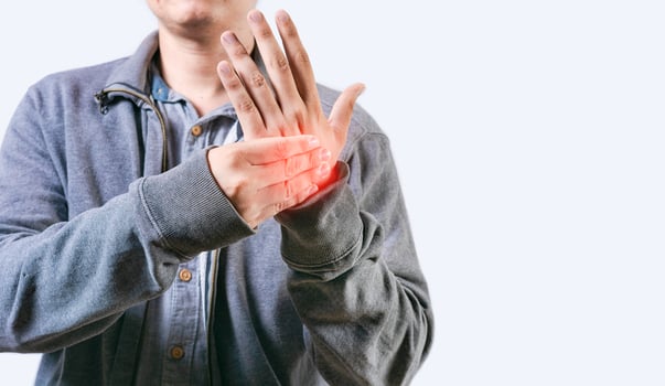 Person with arthritis rubbing hand isolated. People suffering with pain in hand joints photo