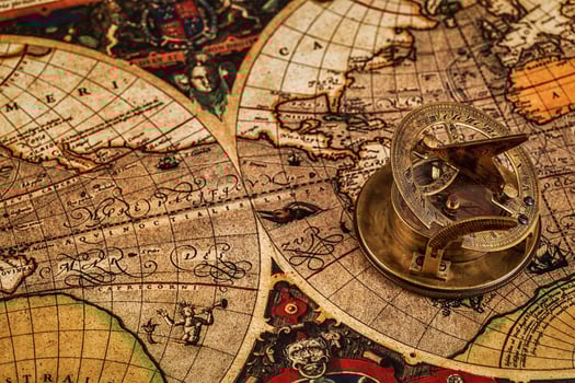 Old vintage compass on ancient map photo