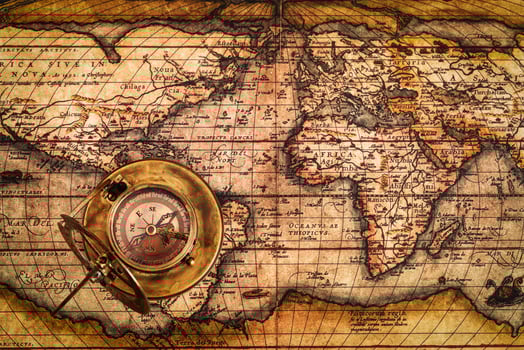 Old vintage compass on ancient map photo