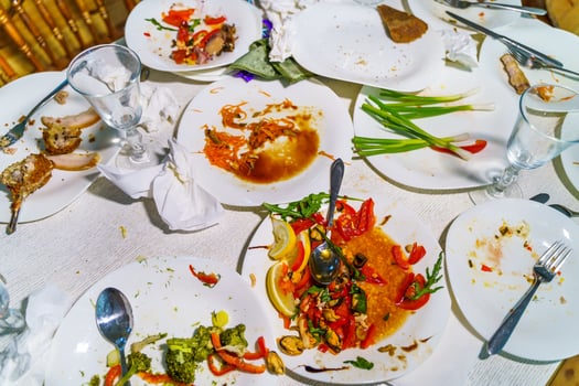 Dirty dishes and glasses on the table after eating. Empty plates with remnants of food after diner. photo