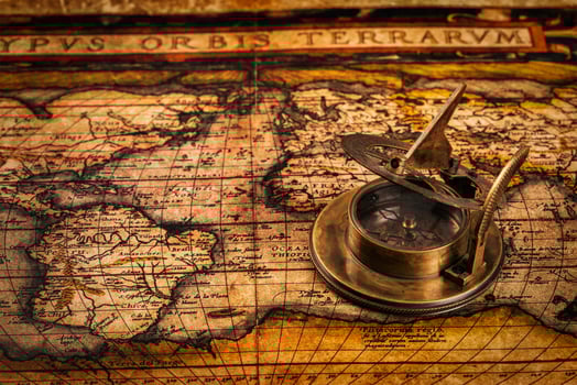 Old vintage compass on ancient map photo