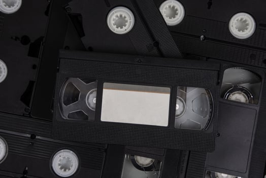 Videotape with blank tags. Pile of VHS video cassettes. Vintage media. Isolate on a white back photo