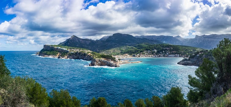 Expansive Coastal Panorama of Port de Soller with Cliffside Buildings, Mallorca photo