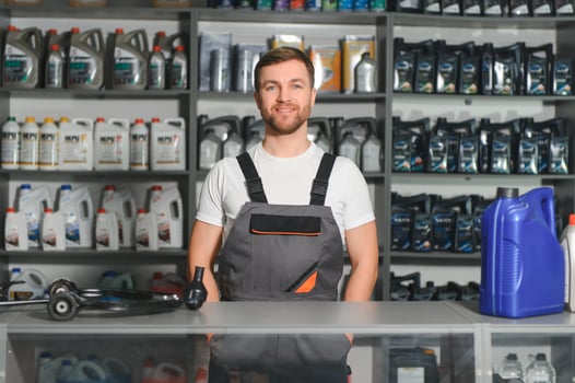 A salesman in an auto parts store. Retail trade of auto parts photo