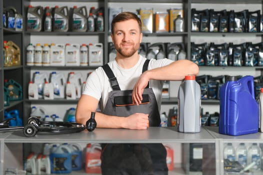 Portrait of a handsome salesman in an auto parts store. The concept of car repair photo