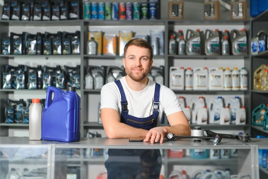 A salesman in an auto parts store. Retail trade of auto parts photo