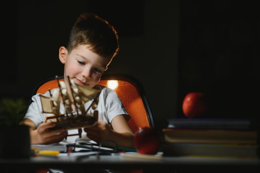 boy doing homework at home in evening photo