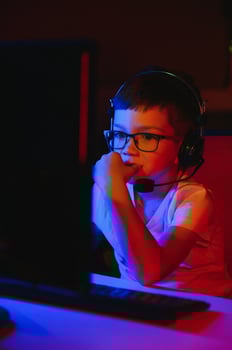 Boy in the headphones is playing a game. photo