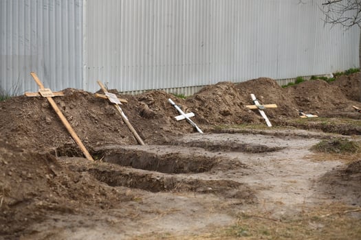 Bucha, Ukraine - April 12, 2022 Empty graves of the killed by the russian army civilans, buried by their neighbors in home yard, after exhumation of their bodies photo