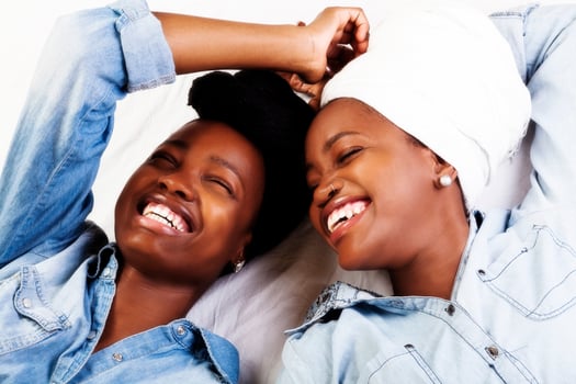 Two African American Women Laughing Portraits Reclining photo