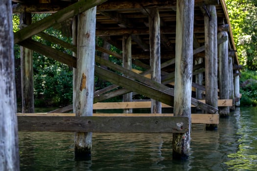Wooden construction under bridge. Vintage bridge bottom view. photo