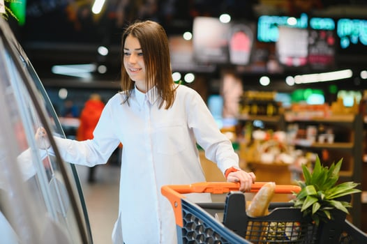 Young woman shopping in the supermarket photo