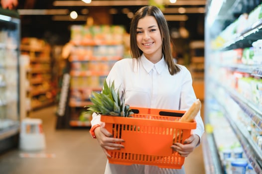 Woman grocery shopping and looking very happy photo