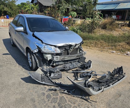 Bronze, gray or grey car broke or accident and crash with 6 wheel truck with trailer on street or road. Damaged or injured on front bumper and car radiator. Broken and insurance of vehicle concept. photo