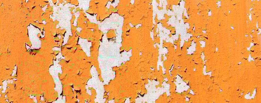 Texture of bright orange paints shabby metal wall photo