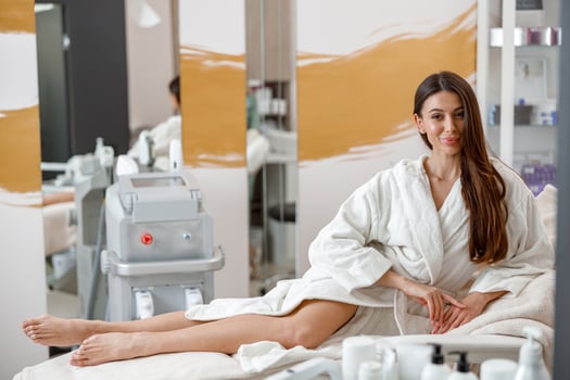 Woman in white bathrobe smiling in spa center on beauty treatments photo