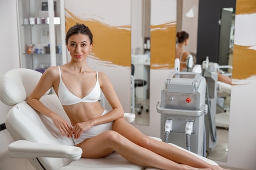 Cheerful young woman with smooth skin ready for laser skin treatment photo