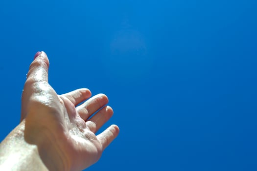 Female arm against a blue sky background. photo