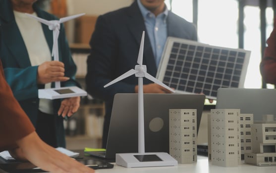 Close-up at tablet, Engineers pointing at tablet with their hands. To jointly design the use of renewable energy with wind and solar energy. Concept of using renewable energy. photo