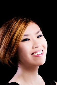 Asian American Woman Smiling Portrait Against Dark Background photo