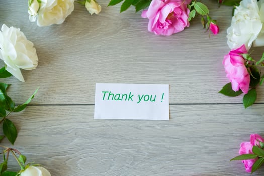 Floral background of pink and white roses on a light wooden photo