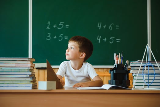 Education and learning. Little schoolboy in classroom. Schoolboy doing homework in classroom at school. Elementary school kid sitting at desk. Education. Kid at school. photo