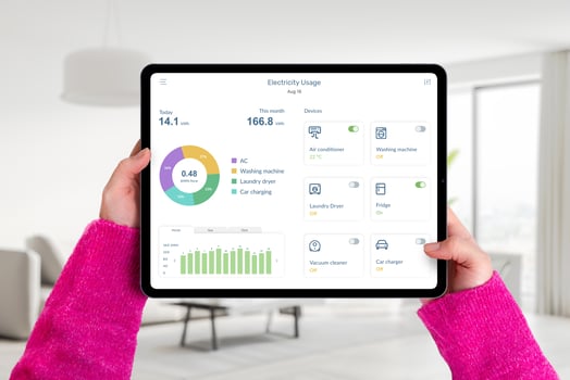 Hands hold tablet in living room with electricity usage app, monitoring consumption and controlling home devices. Concept of smart energy management photo