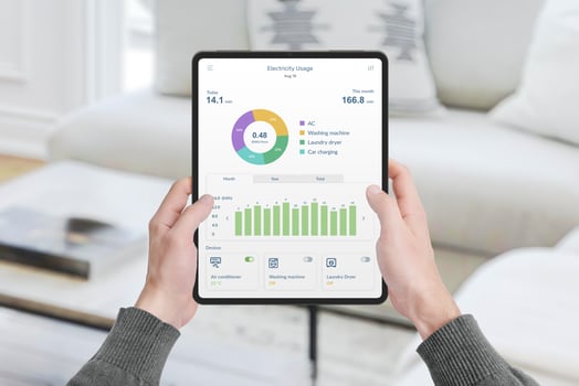 Hands hold tablet with app monitoring electricity consumption in house. Concept of energy management, technology, and smart living solutions photo