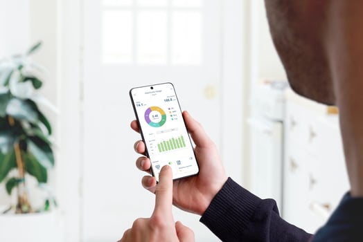 Guy monitors home electricity usage with smart home app. Concept of energy efficiency, technology, and household management for sustainable living photo