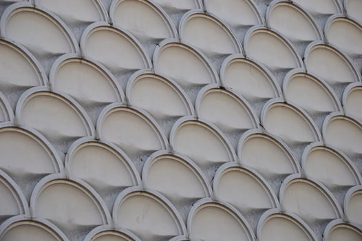 Element of decoration of the facade of a building. Texture of gray marble pattern with round elements. photo