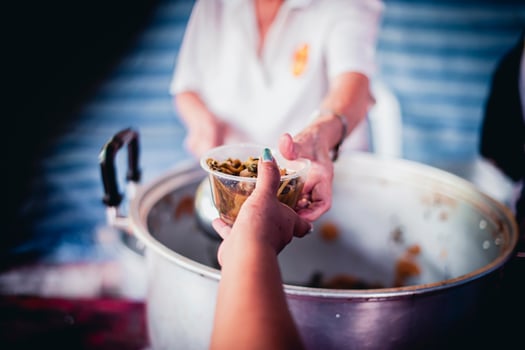 The hands of the poor apply for food from rich people who donate food. photo