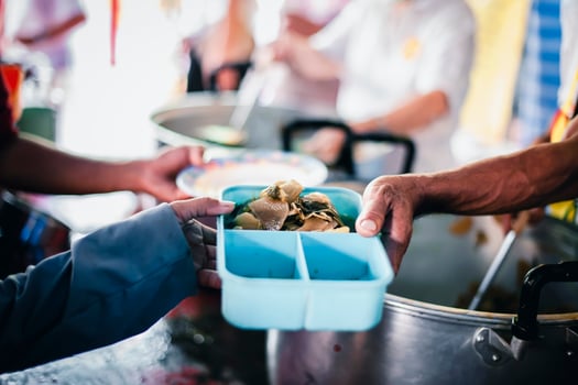 The hands of the poor apply for food from rich people who donate food. photo