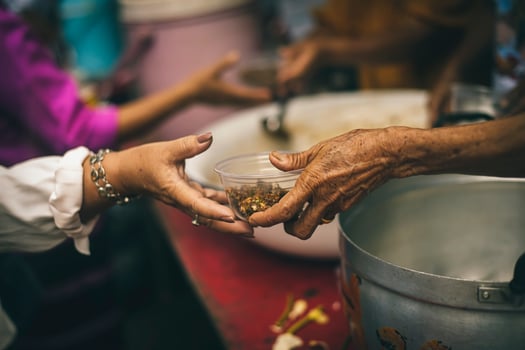Hands of poor people asking for food from volunteers helping concept of food donation photo