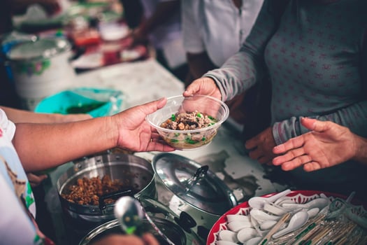 Hands of poor people asking for food from volunteers helping concept of food donation photo