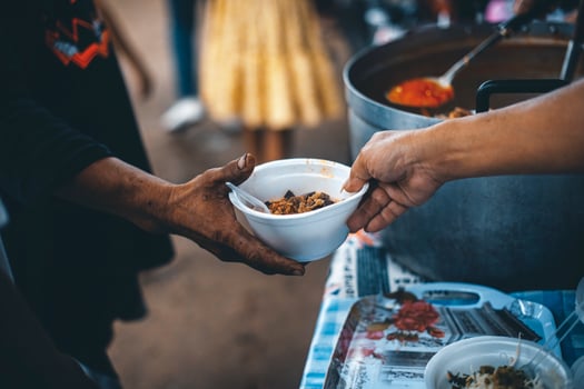 Hands of poor people asking for food from volunteers helping concept of food donation photo