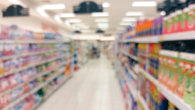 supermarket aisle and shelves blurred background. grocery store retail business concept photo